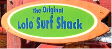 A wooden surfboard-shaped signed that reads "The Original Lolo Surf Shack". The word Lolo is followed immediately by a trademark registration symbol.
